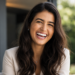 Woman smiling confidently with a natural-looking Hollywood Smile after personalized cosmetic dental treatment.