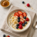 Greek yogurt topped with fresh berries, banana, chia seeds, and honey, a soft and protein-rich meal recommended after dental implant surgery.